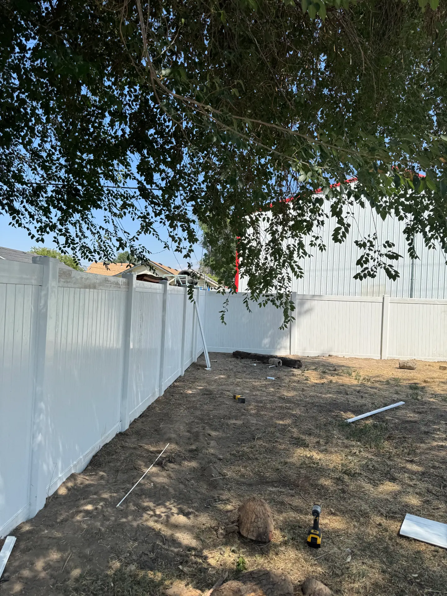 Long white vinyl privacy fence line around a backyard — R & R Construction, Burley Idaho